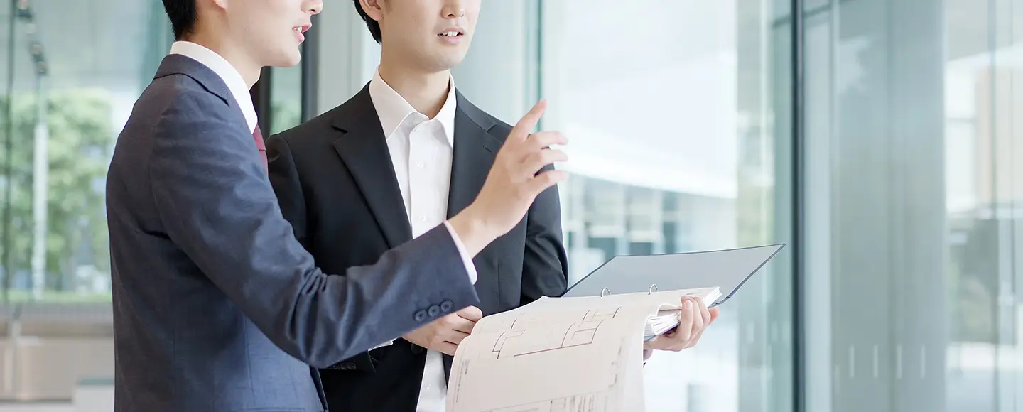 スタッフが手元の資料を見ながら打合せている様子